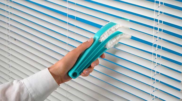 images of a man cleaning blinds